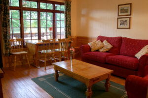 living room river edge lodge, with 2 sofas, coffee table and dining table