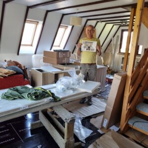 John standing in the water-damaged Lodge 14, surrounded by the bits for the new kitchen